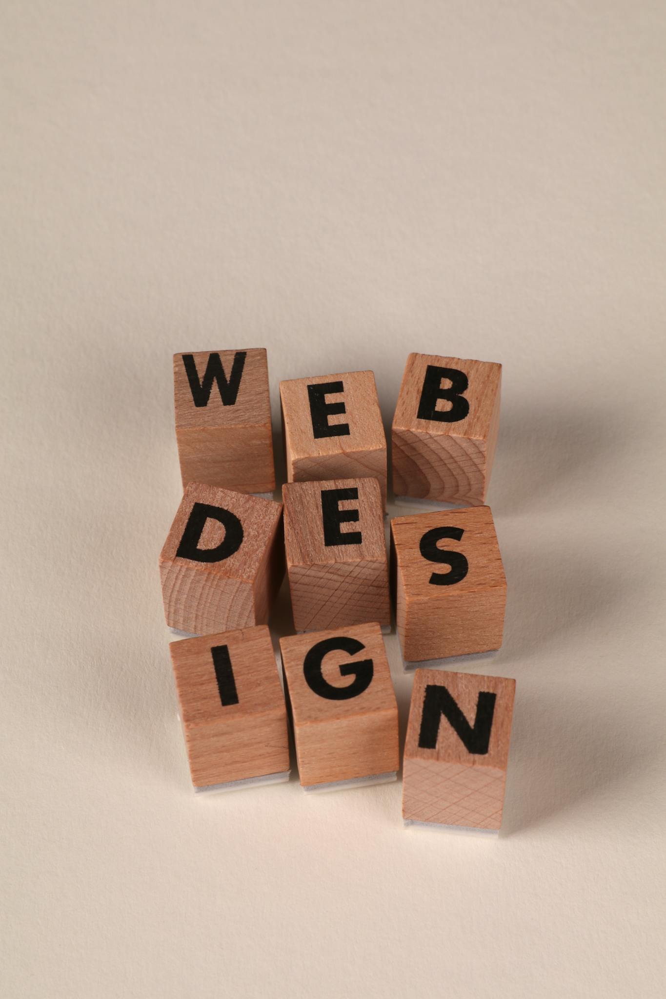 Wooden blocks arranged to spell 'Web Design'. Perfect for creative, digital content themes.